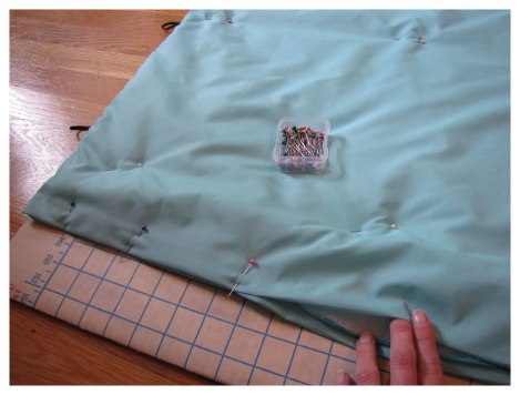 Pin short end closed and pin rest of sleeping bag for quilting